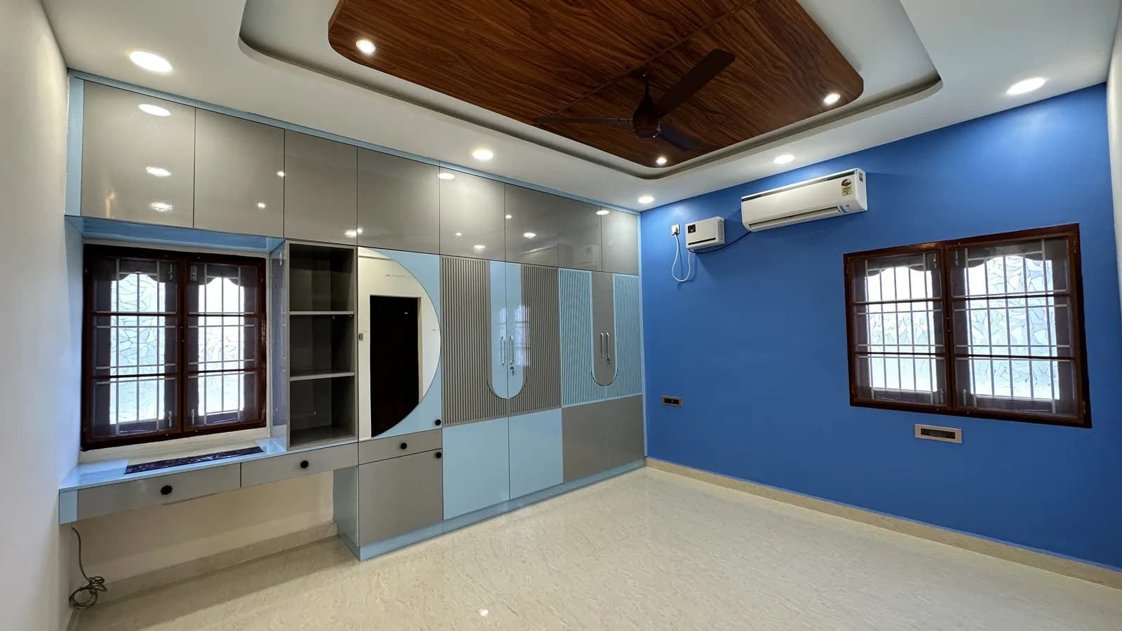 Bedroom with custom wardrobe and TV unit interior design by Home Admire, Chennai